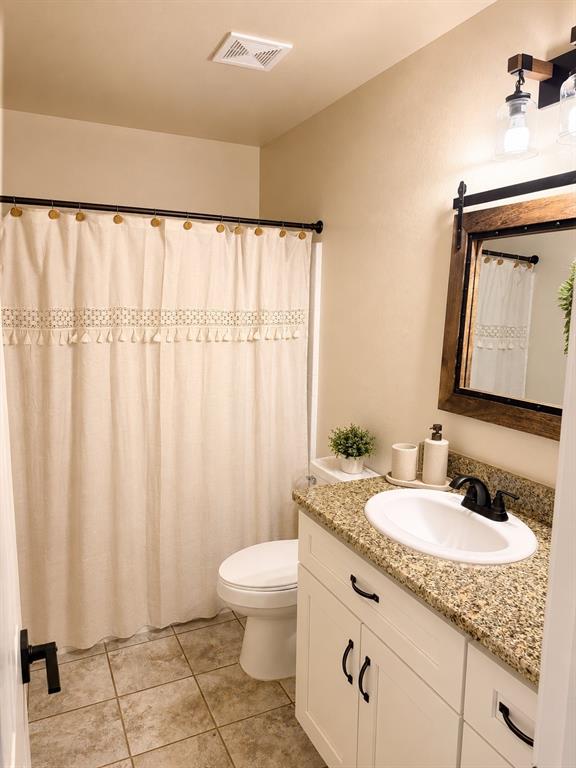 408 South Cleburne Whitney Road Rio Vista, TX 76093 - Photo 14 of 16 a bathroom with a granite countertop sink and a mirror