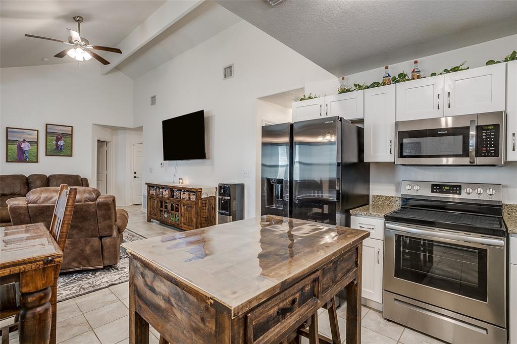 408 South Cleburne Whitney Road Rio Vista, TX 76093 - Photo 8 of 16 a kitchen with stainless steel appliances a stove a sink a microwave a dining table and chairs