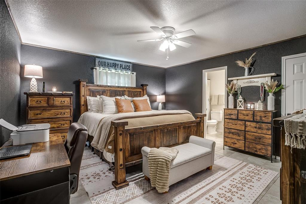 408 South Cleburne Whitney Road Rio Vista, TX 76093 - Photo 10 of 16 a bedroom with a bed wooden floor and window