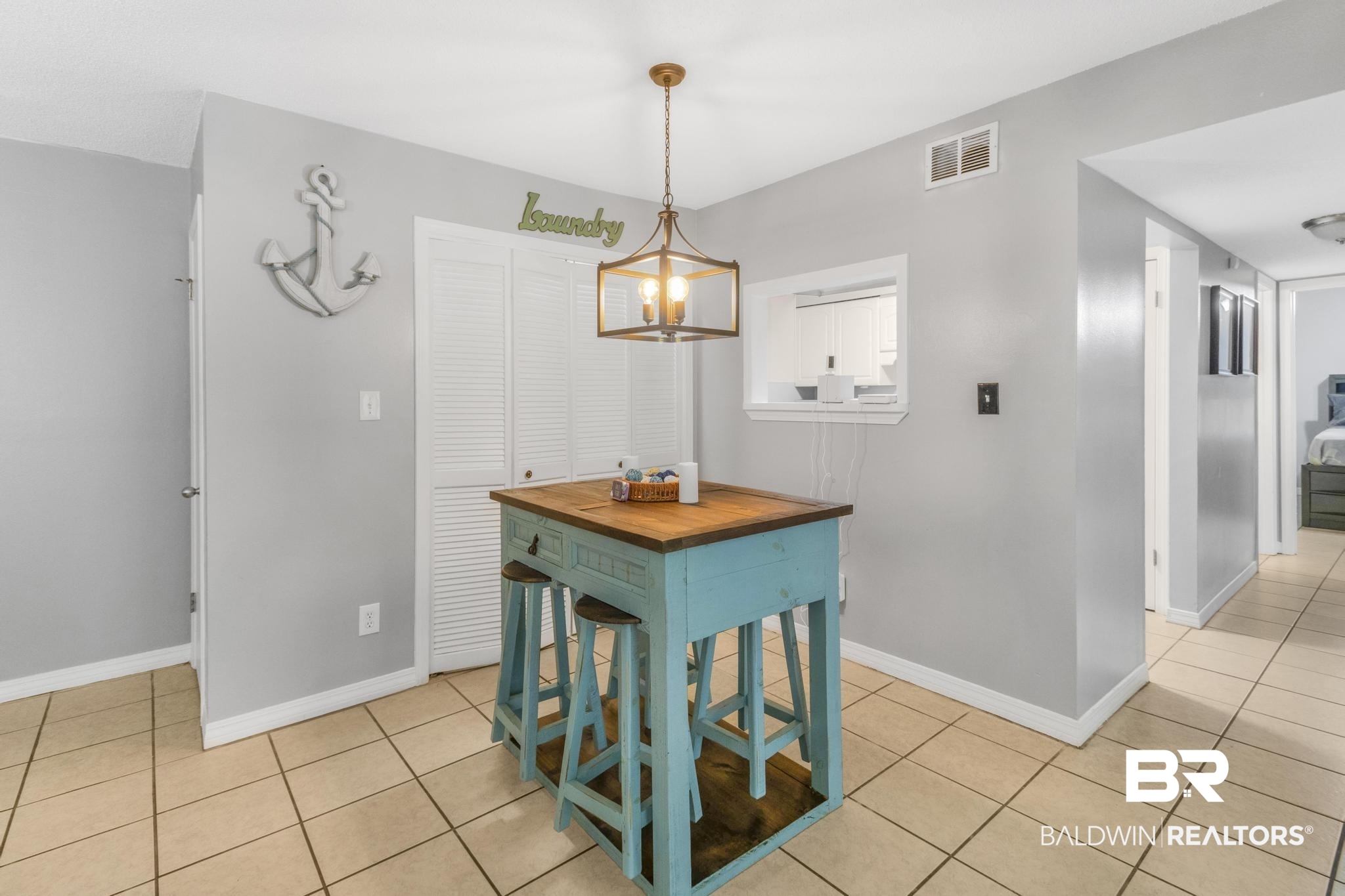 110 5th Street, Unit A 103 Daphne, AL 36526 - Photo 8 of 28 Dining space with light tile patterned floors and an inviting chandelier