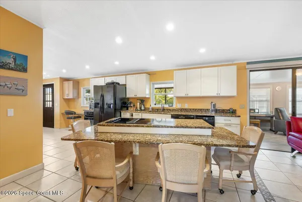 a kitchen with a table chairs stove and cabinets