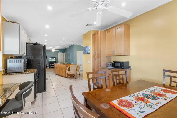 a large kitchen with a table and chairs