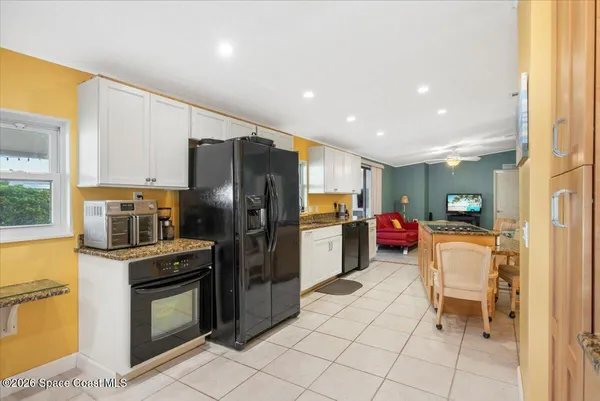 a kitchen with a refrigerator and a sink