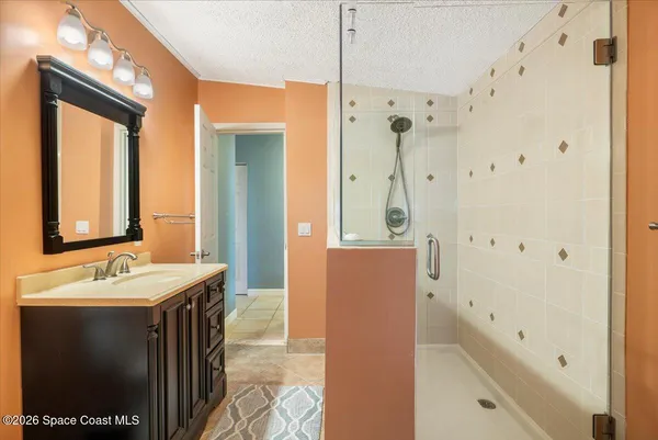 a spacious bathroom with a shower and a sink