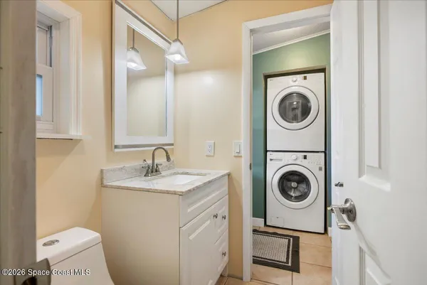 a utility room with sink dryer and washer