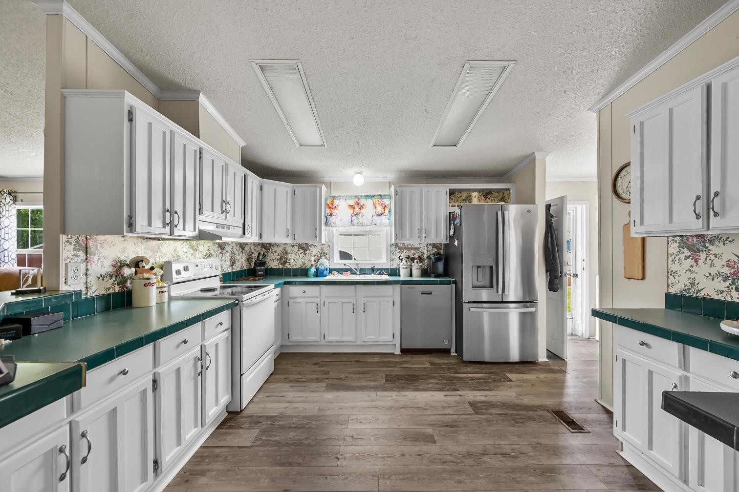 6439 Cedar Grove Road Big Sandy, TN 38221 - Photo 7 of 38 a kitchen with a refrigerator sink cabinets and wooden floor