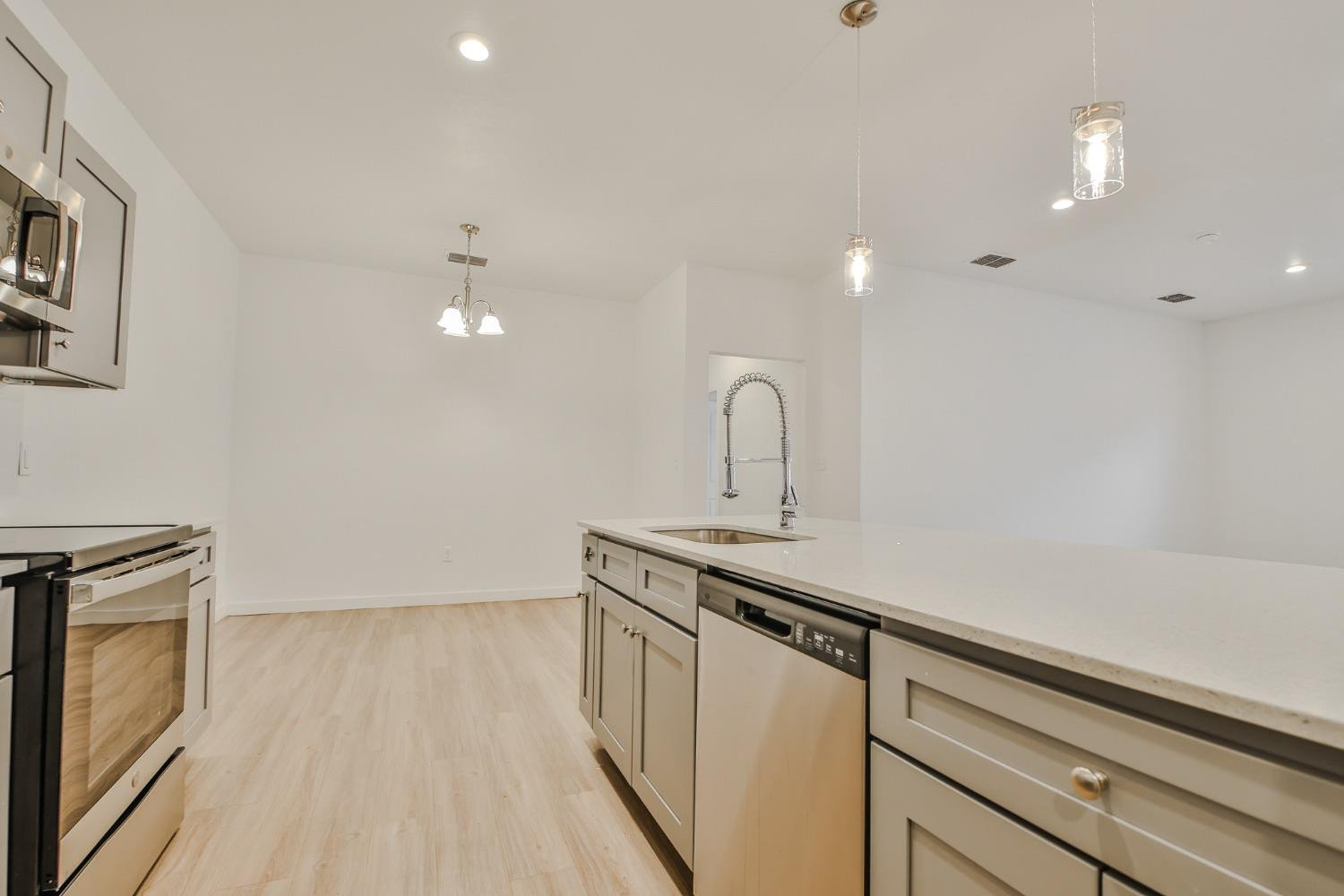 5508 Itasca Street Lubbock, TX 79416 - Photo 8 of 25 a kitchen with a sink a refrigerator and cabinets
