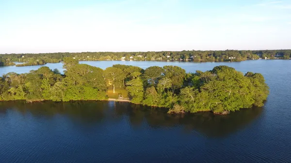 an aerial view of a houses with ocean view