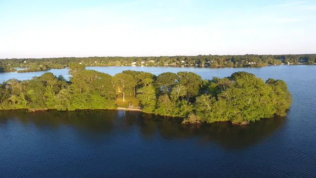 an aerial view of a houses with ocean view