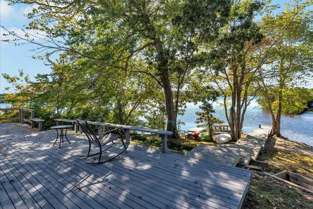a living room with furniture a fireplace and a large window