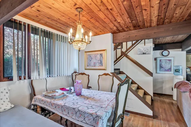 a living room with furniture flat screen tv and outdoor view