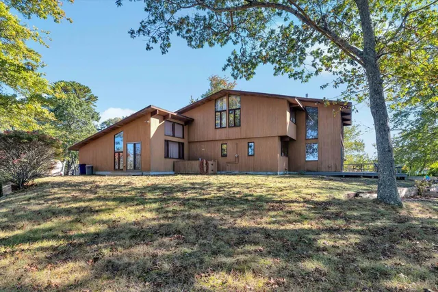 a view of a wooden deck and a yard