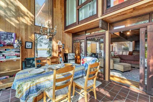 a bedroom with a bed and a large mirror on the dresser