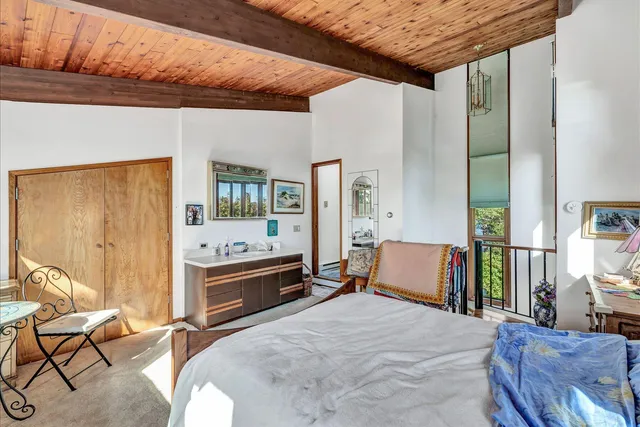 a bed room with a bed and a television