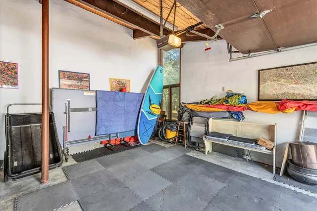 a bedroom with a bed and a dresser next to a window