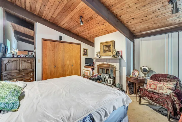 a bedroom with a bed and a table with chair