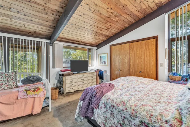an aerial view of a house with a garden and lake view