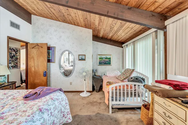 an aerial view of a residential houses with outdoor space and lake view