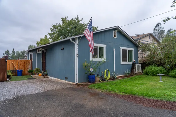 a front view of house with yard outdoor seating and barbeque oven