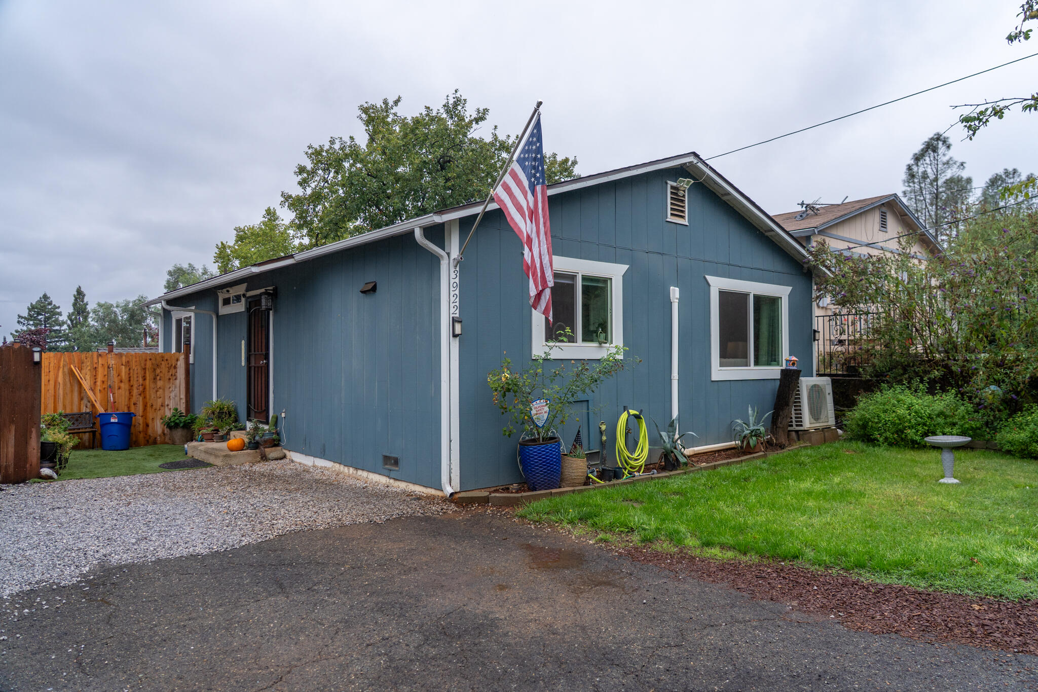 a front view of house with yard outdoor seating and barbeque oven