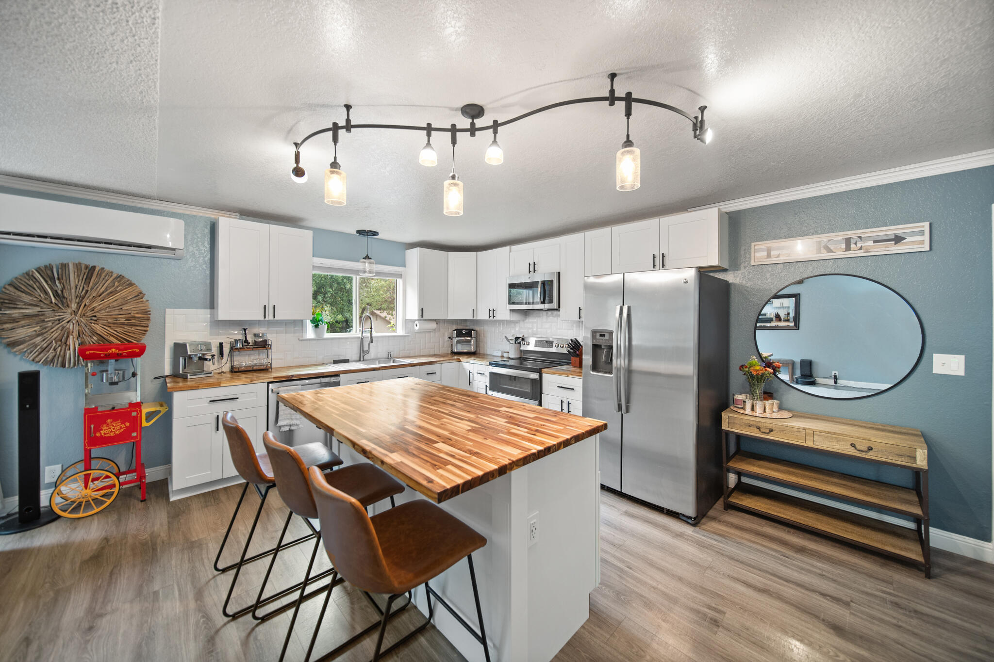 3922 Laredo Street Shasta Lake, CA 96019 - Photo 11 of 35 a dining room with stainless steel appliances granite countertop a dining table chairs refrigerator and sink