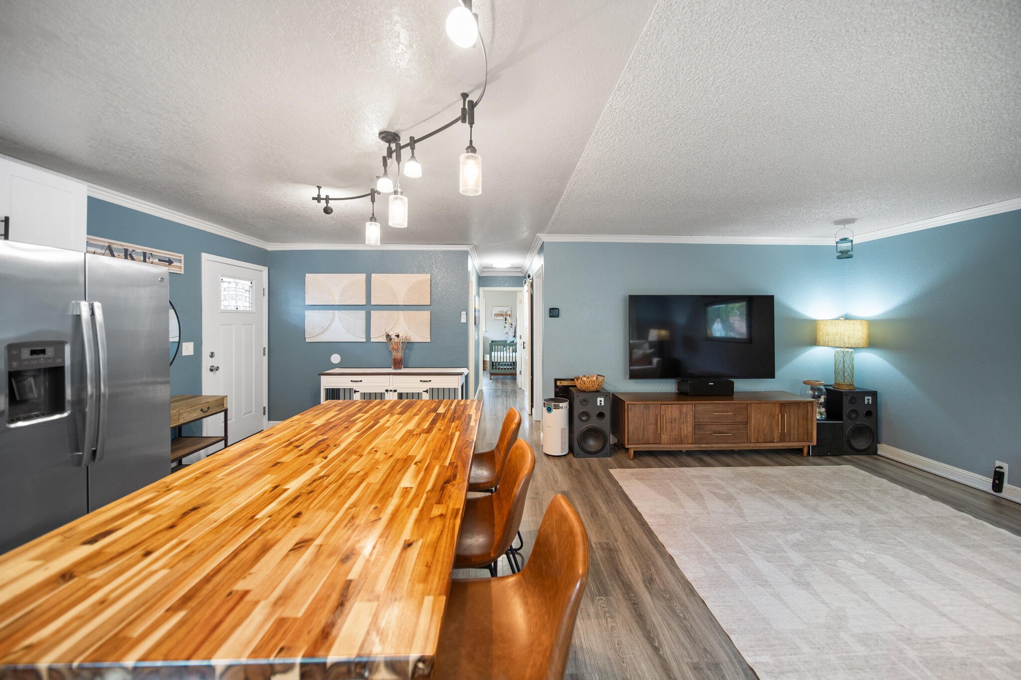 3922 Laredo Street Shasta Lake, CA 96019 - Photo 12 of 35 a large bedroom with a bed a flat screen tv and a chandelier