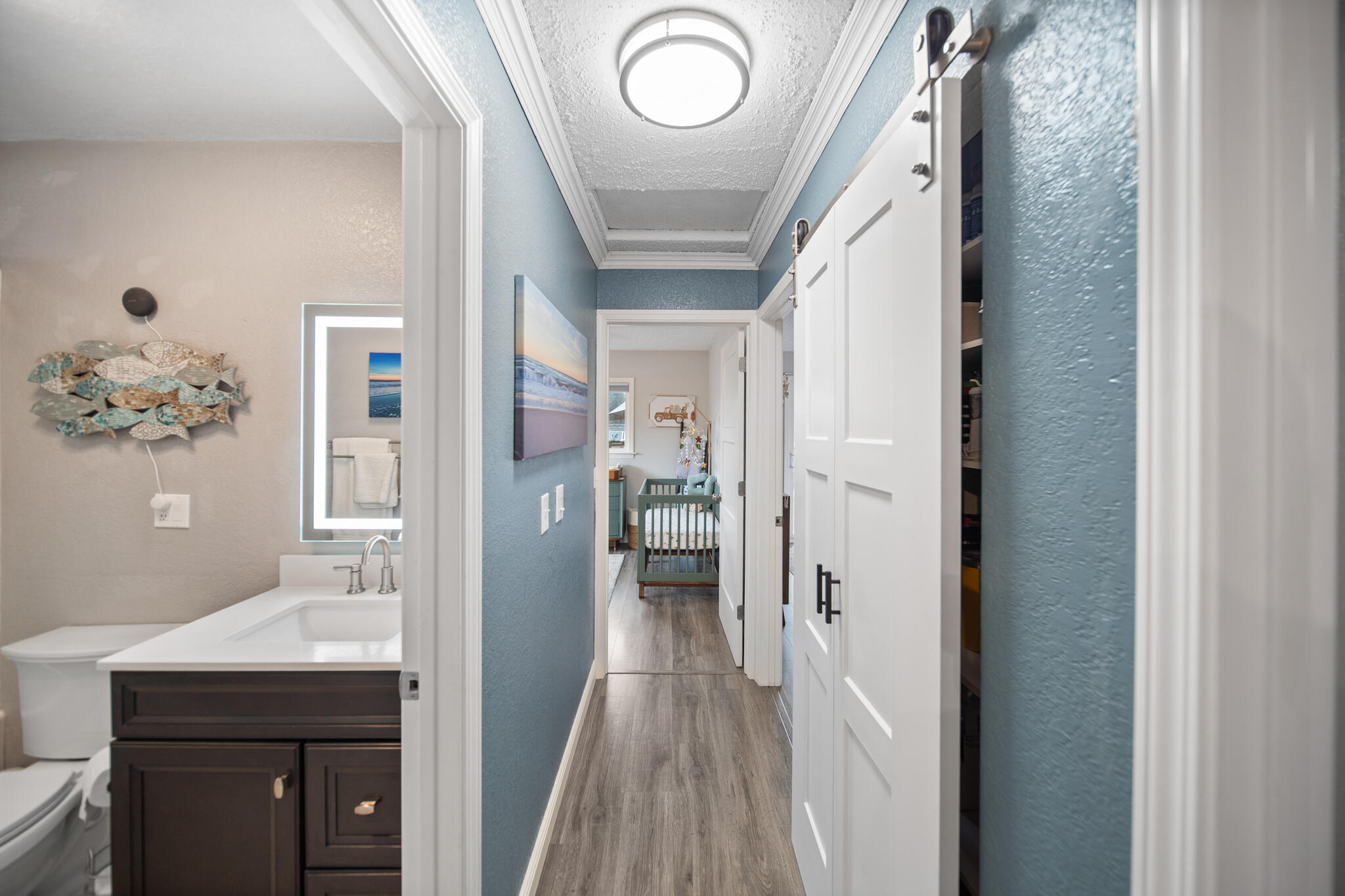 3922 Laredo Street Shasta Lake, CA 96019 - Photo 13 of 35 a view of a hallway with wooden floor and a bathroom
