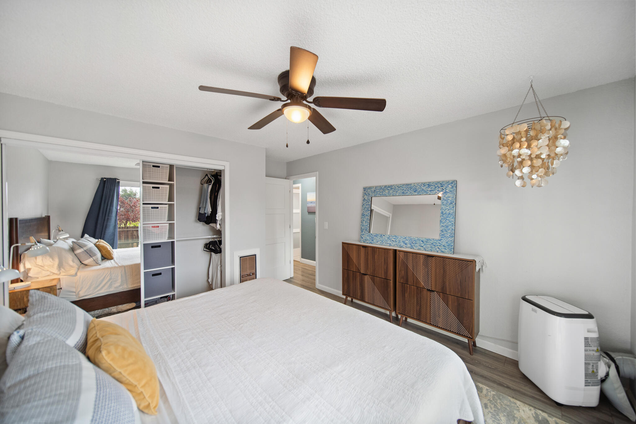 3922 Laredo Street Shasta Lake, CA 96019 - Photo 16 of 35 a bedroom with a bed and a chandelier