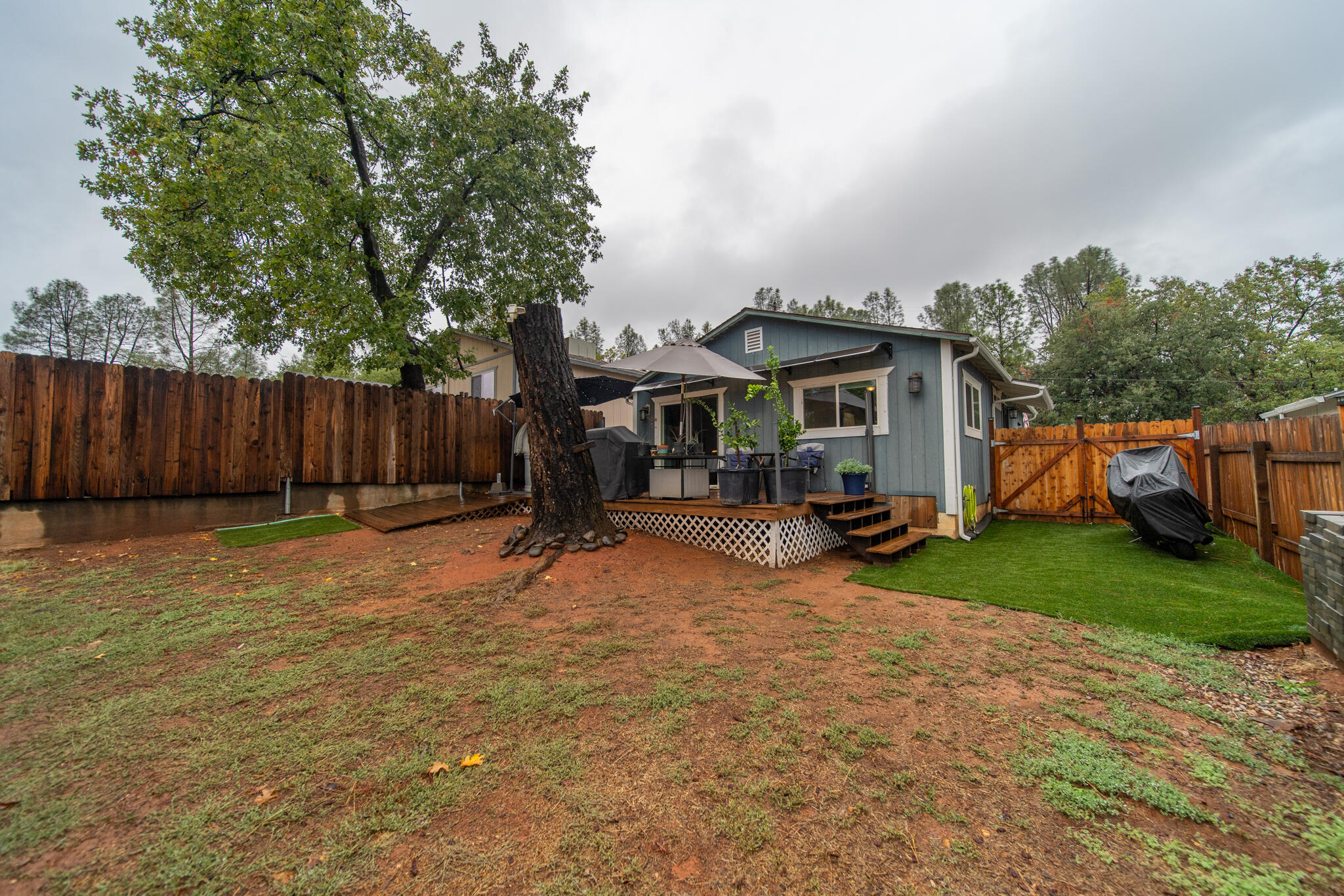 3922 Laredo Street Shasta Lake, CA 96019 - Photo 31 of 35 a view of a house with backyard and a tree