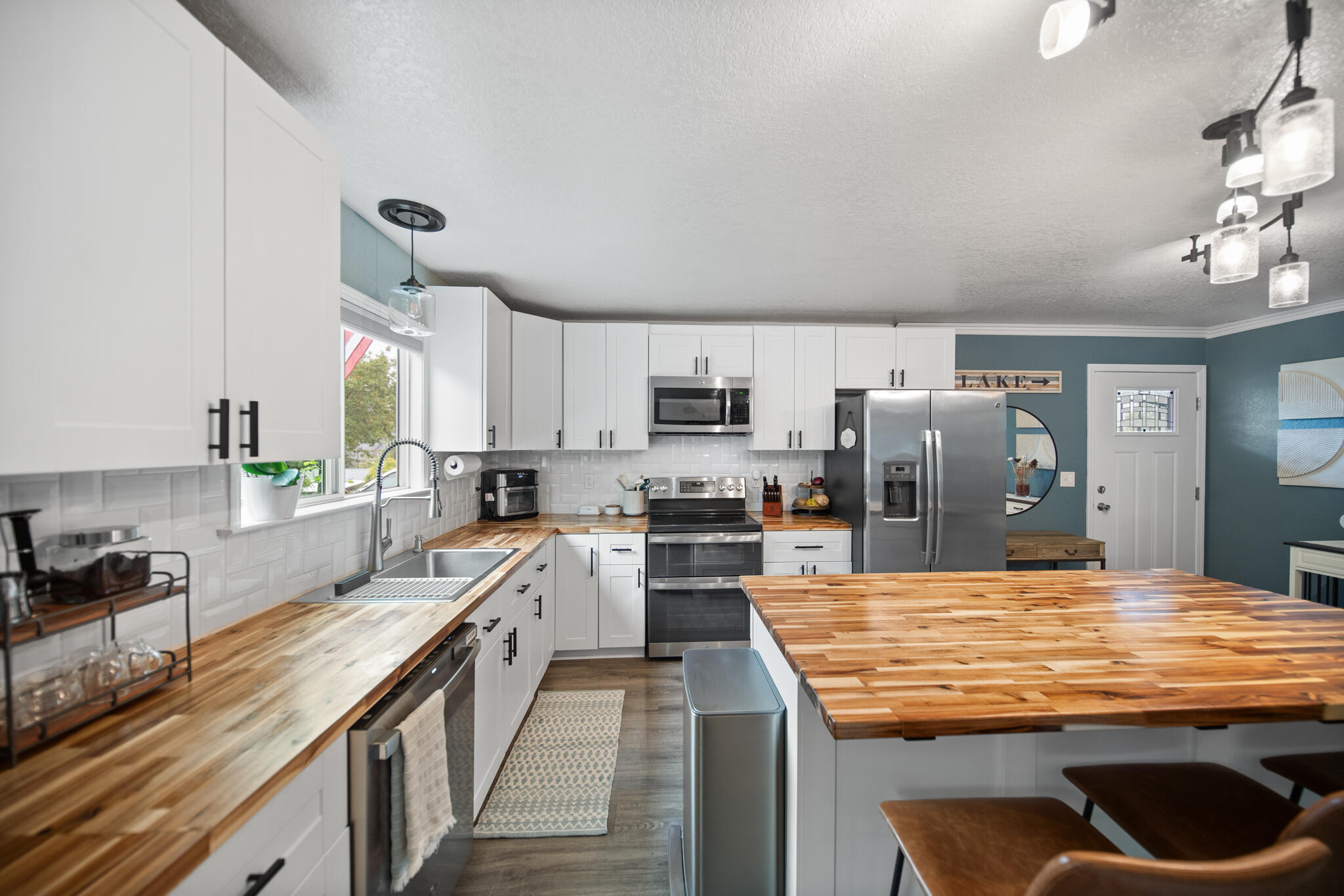 3922 Laredo Street Shasta Lake, CA 96019 - Photo 9 of 35 a kitchen with stainless steel appliances granite countertop a stove refrigerator sink and cabinets