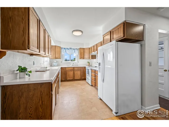 a kitchen with stainless steel appliances a refrigerator sink and cabinets