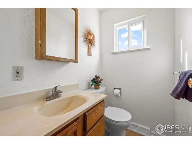a bathroom with a sink toilet and mirror