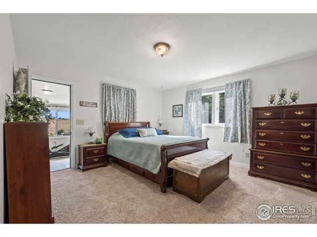 a spacious bedroom with a bed and a dresser