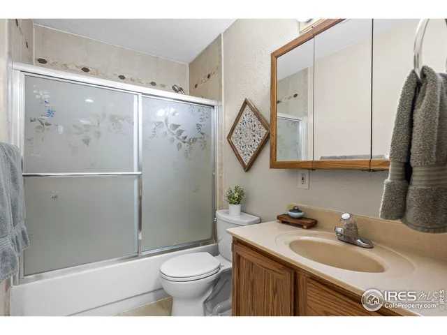 a bathroom with a toilet a sink and a mirror