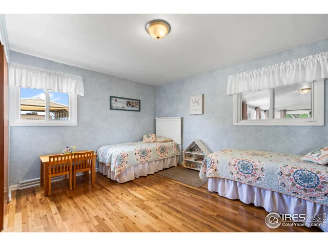 a bedroom with a bed and a dresser in it