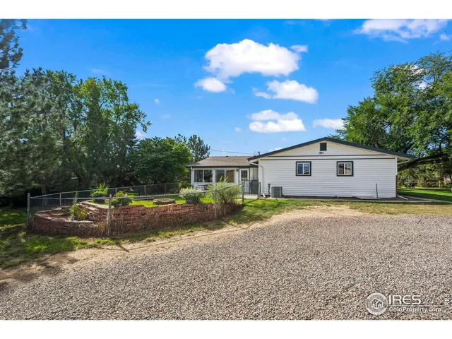 a view of a house with backyard porch and sitting area