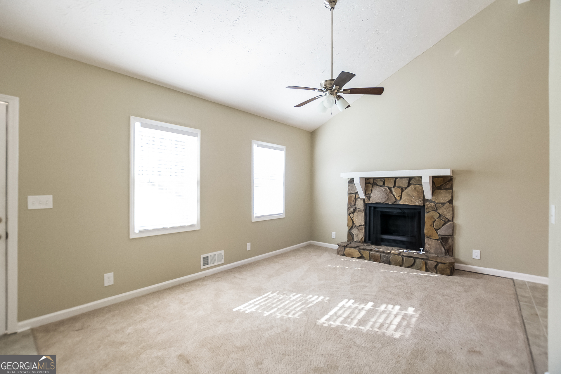 302 West Paulding Boulevard Dallas, GA 30157 - Photo 4 of 15 a view of an empty room with a fireplace and a window