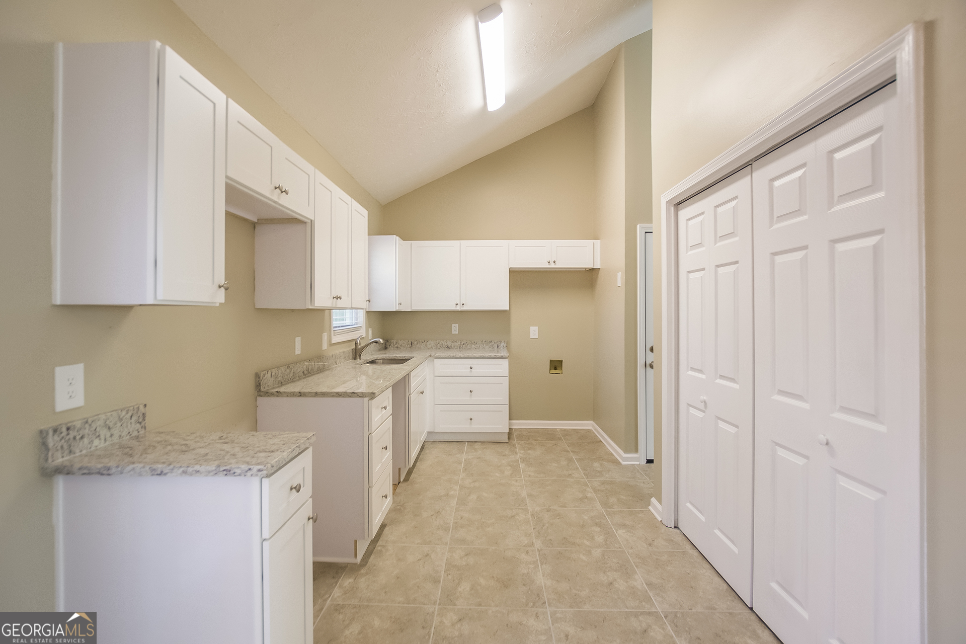 302 West Paulding Boulevard Dallas, GA 30157 - Photo 6 of 15 a large white kitchen with granite countertop a sink