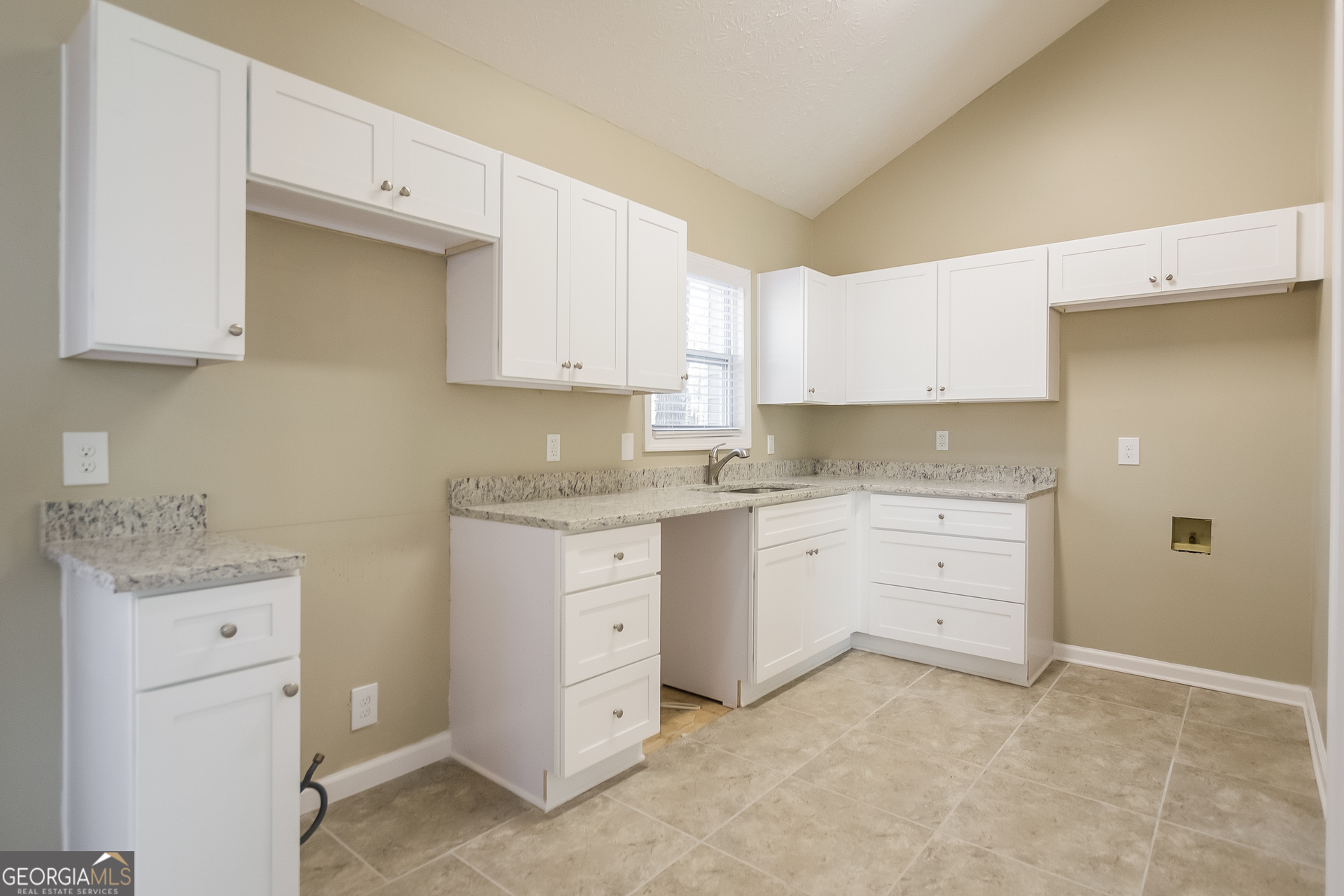 302 West Paulding Boulevard Dallas, GA 30157 - Photo 7 of 15 a room with cabinets appliances a sink and a stove top oven