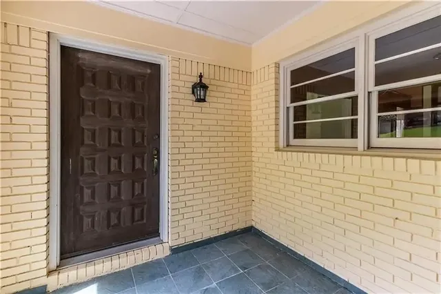 a view of front door of house and a window