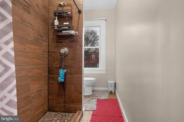 a bathroom with a toilet and a shower