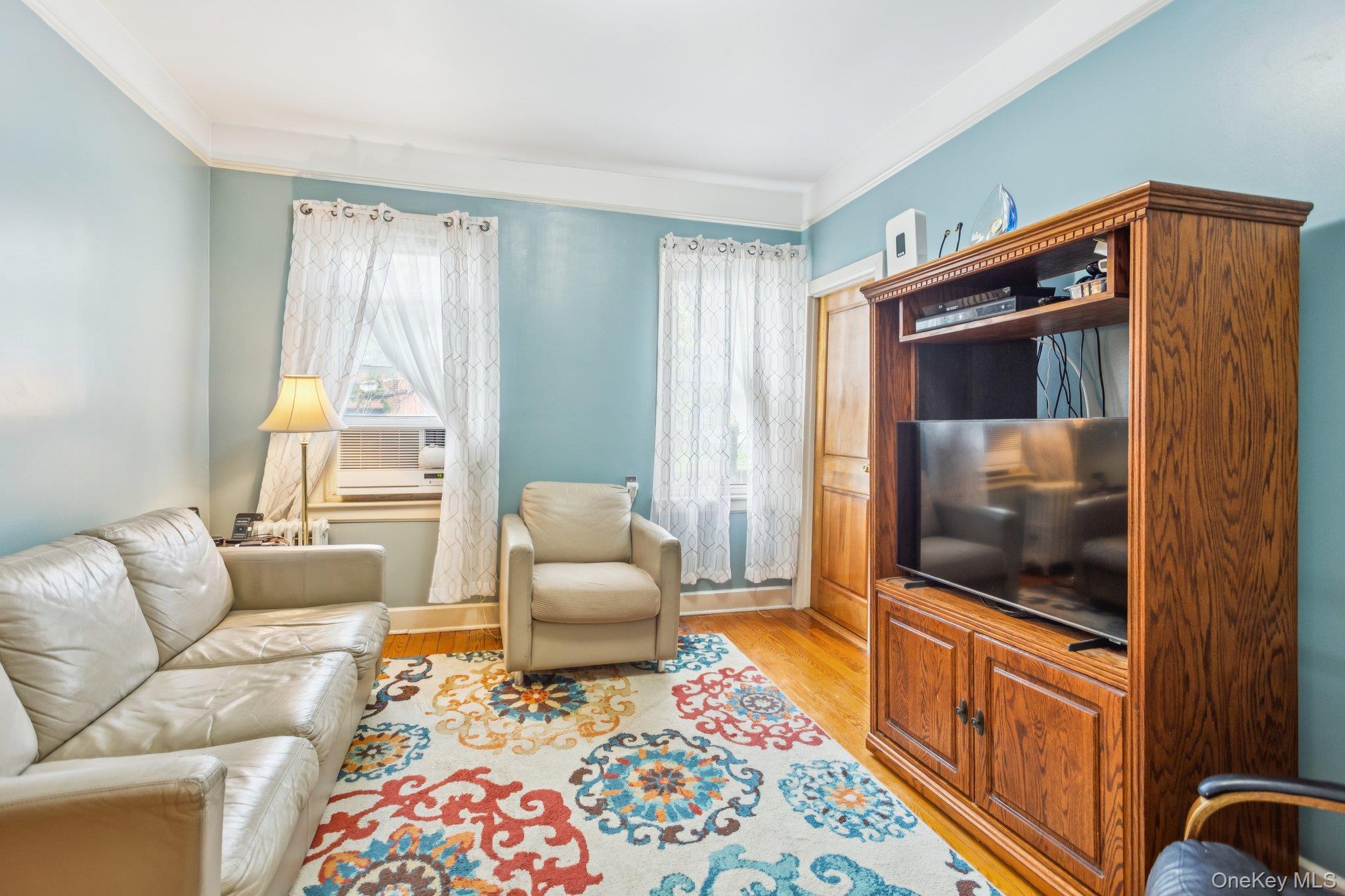 45-09 104th Street Queens, NY 11368 - Photo 14 of 21 a living room with furniture and a flat screen tv