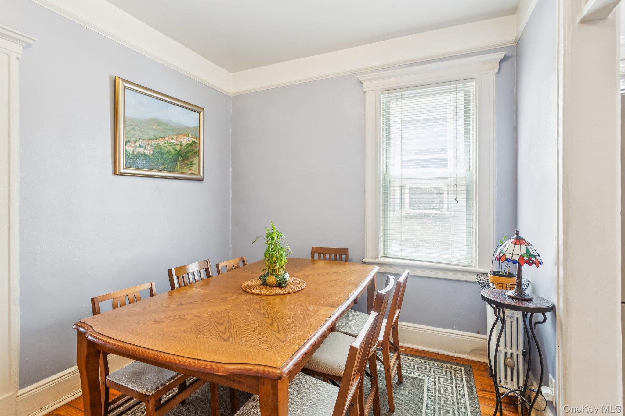 45-09 104th Street Queens, NY 11368 - Photo 3 of 21 a view of a dining room with furniture and wooden floor