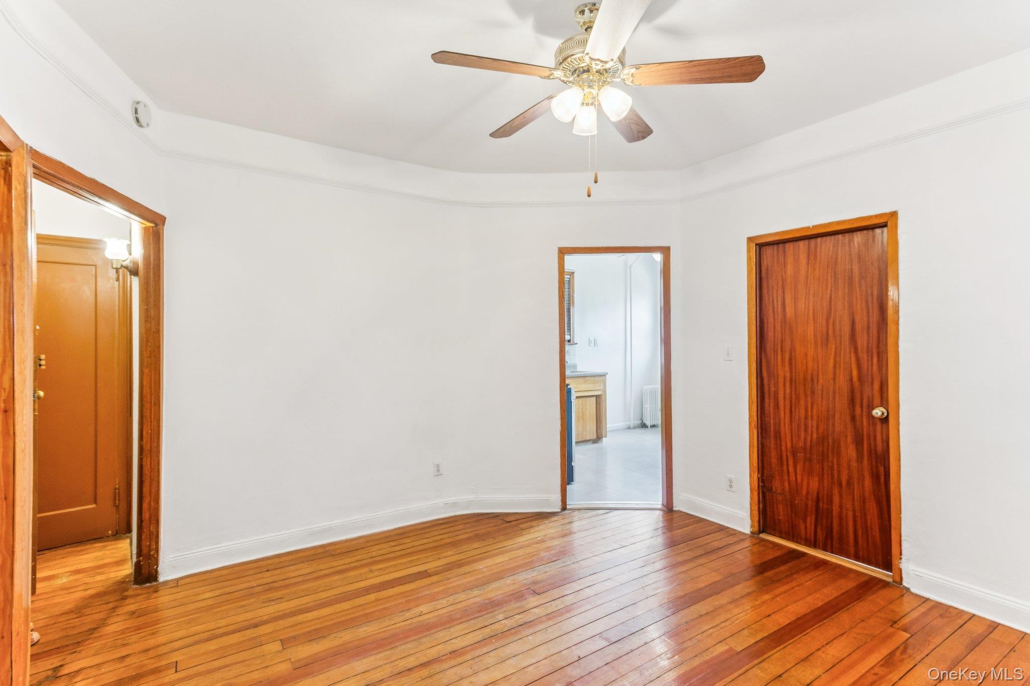 45-09 104th Street Queens, NY 11368 - Photo 7 of 21 a view of an empty room with wooden floor