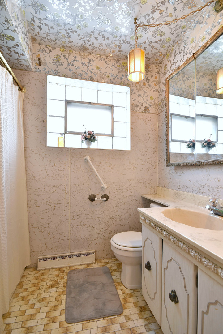 7555 Monroe Street Niles, IL 60714 - Photo 12 of 41 a bathroom with a sink toilet and window