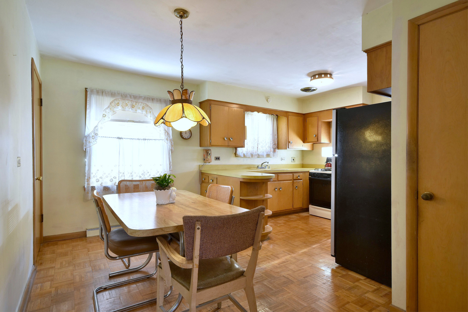 7555 Monroe Street Niles, IL 60714 - Photo 15 of 41 a kitchen with stainless steel appliances kitchen island granite countertop dining table chairs and a window