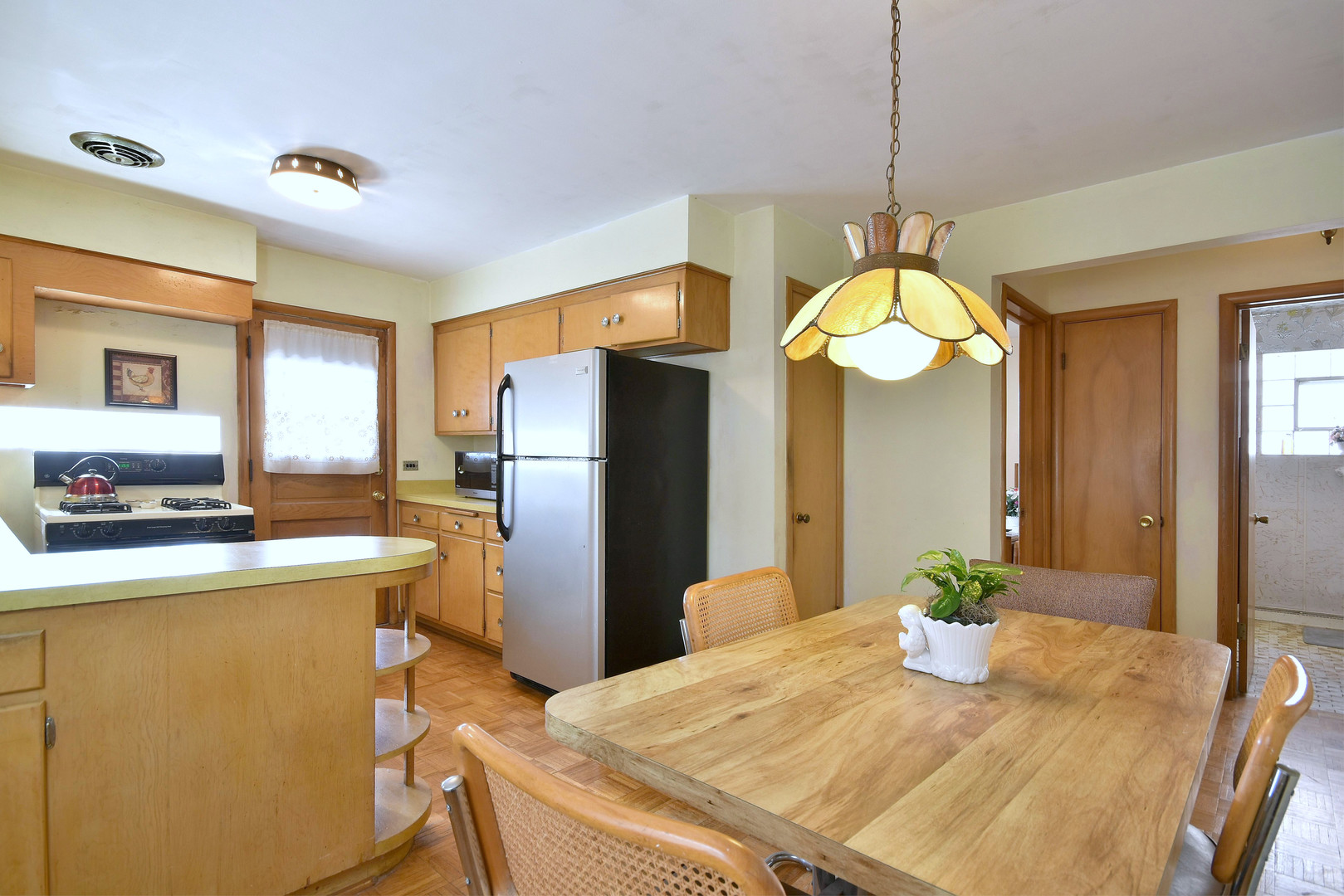 7555 Monroe Street Niles, IL 60714 - Photo 18 of 41 a kitchen with refrigerator and windows