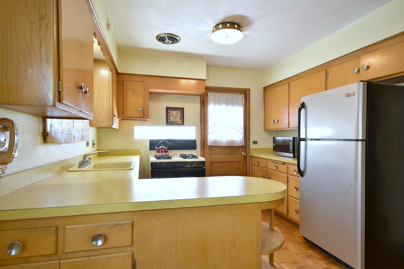7555 Monroe Street Niles, IL 60714 - Photo 19 of 41 a kitchen with a refrigerator and a sink