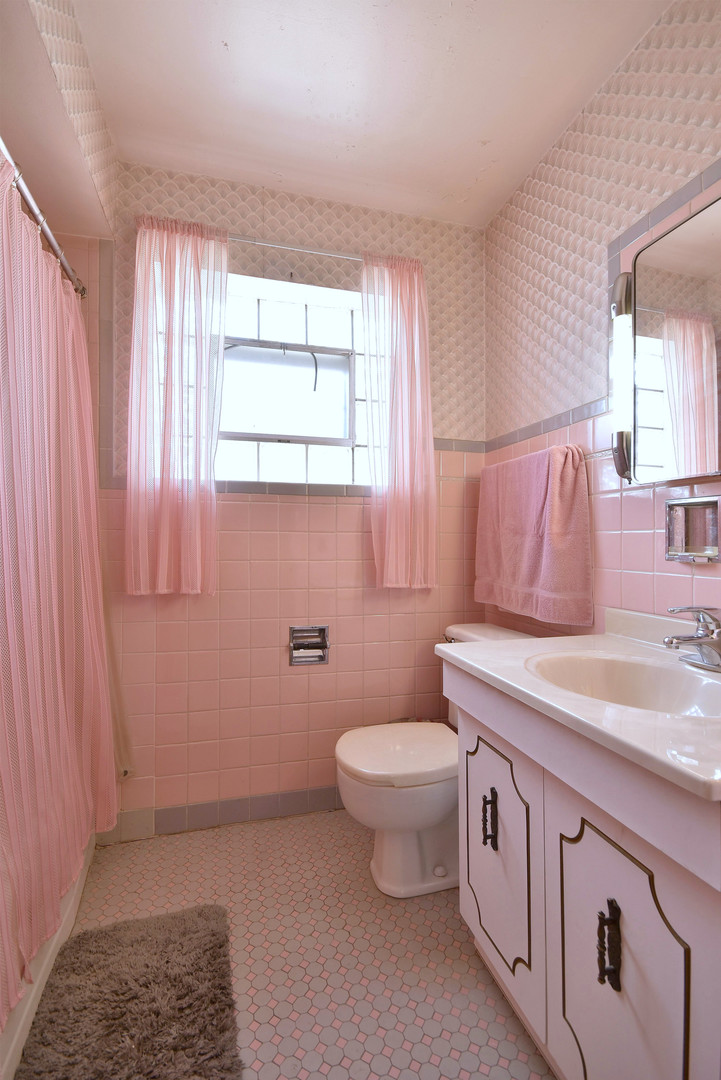 7555 Monroe Street Niles, IL 60714 - Photo 27 of 41 a bathroom with a toilet a sink and a window
