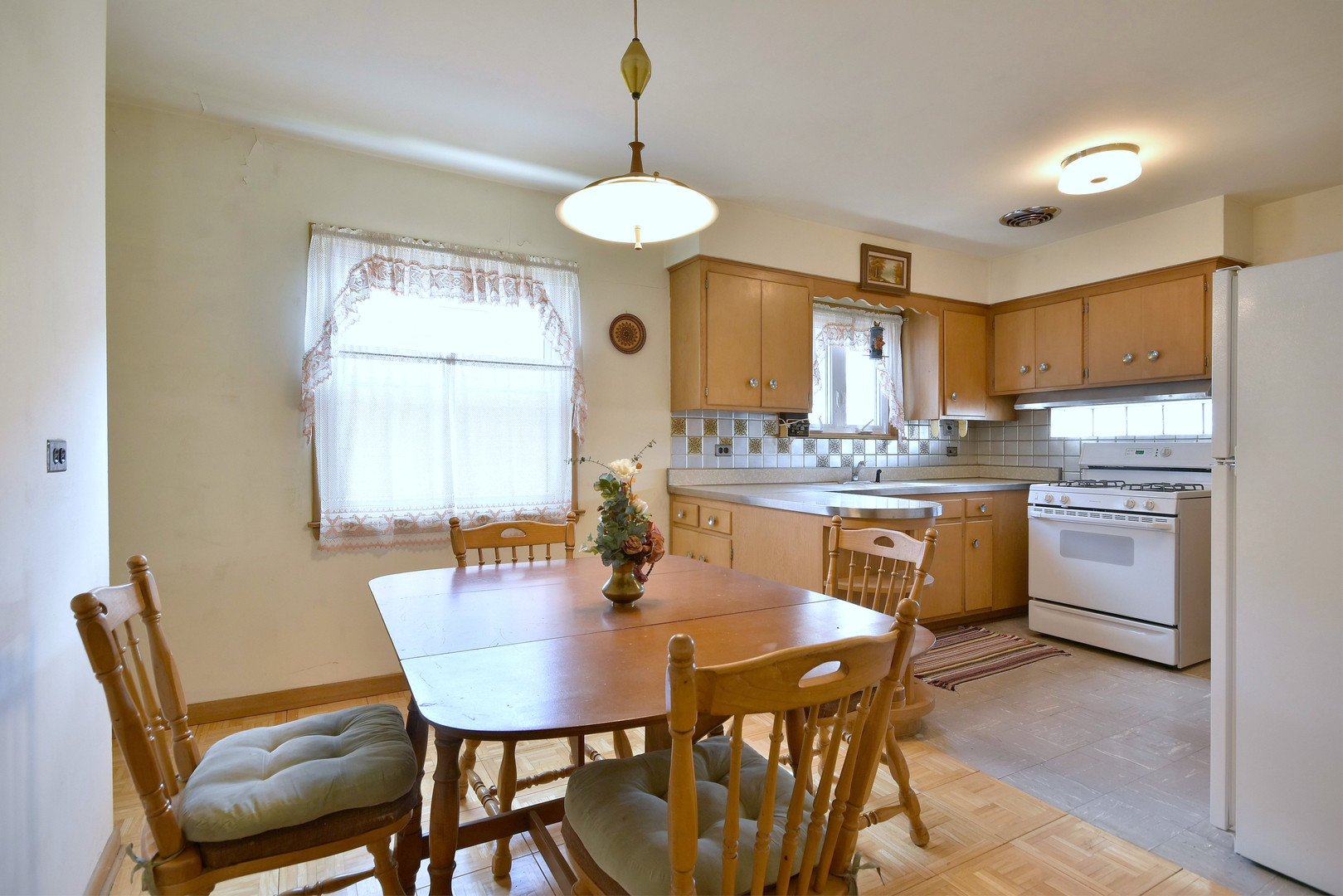7555 Monroe Street Niles, IL 60714 - Photo 28 of 41 a kitchen with a dining table chairs stainless steel appliances and cabinets